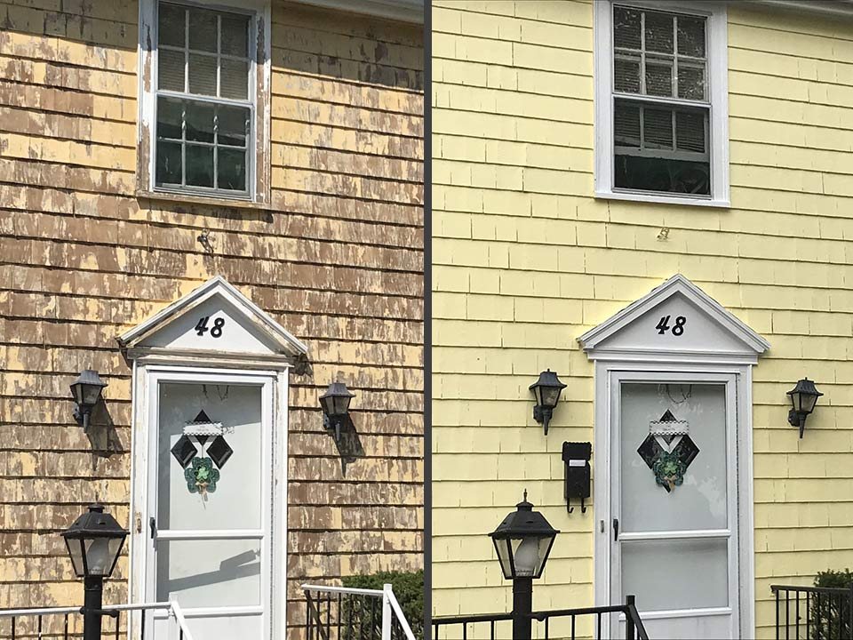 Shingled home repainted soft yellow with white trim